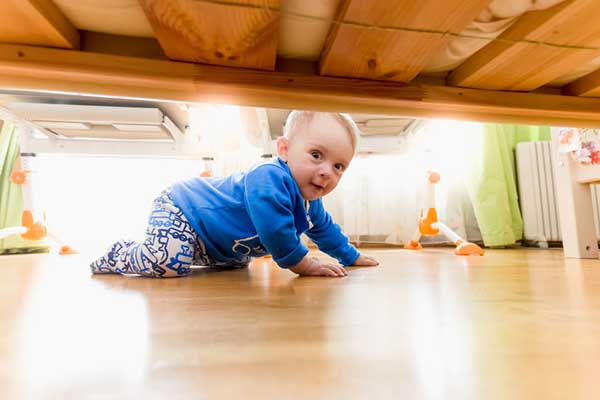 baby looking under bed